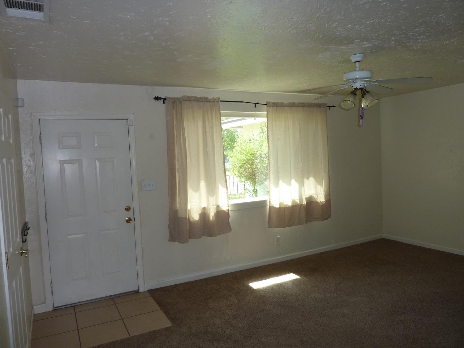 2629 East Richert Avenue Fresno, CA 93726 - Photo 5 of 32 an empty room with windows