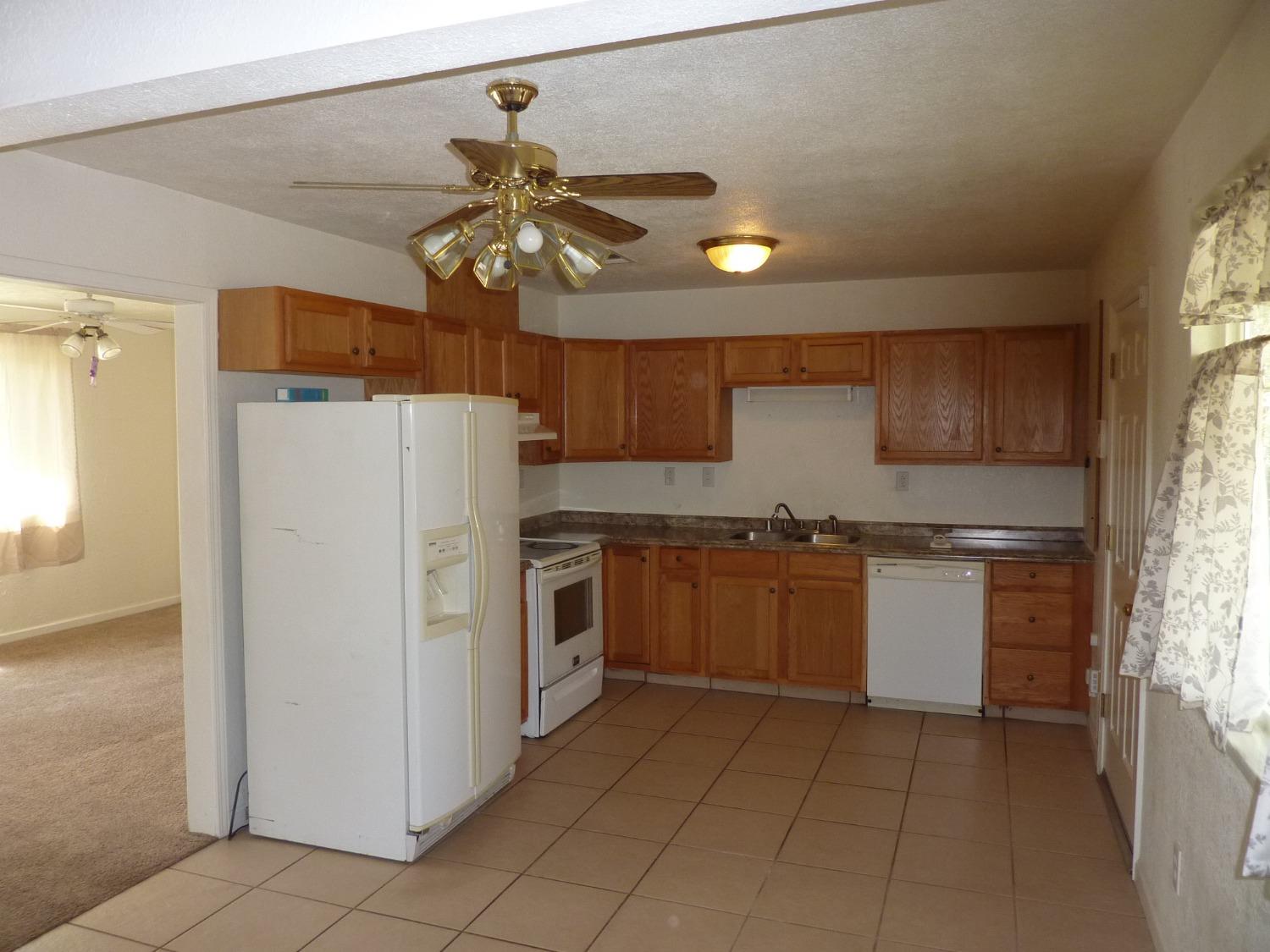 2629 East Richert Avenue Fresno, CA 93726 - Photo 7 of 32 a kitchen with a refrigerator a sink and dishwasher