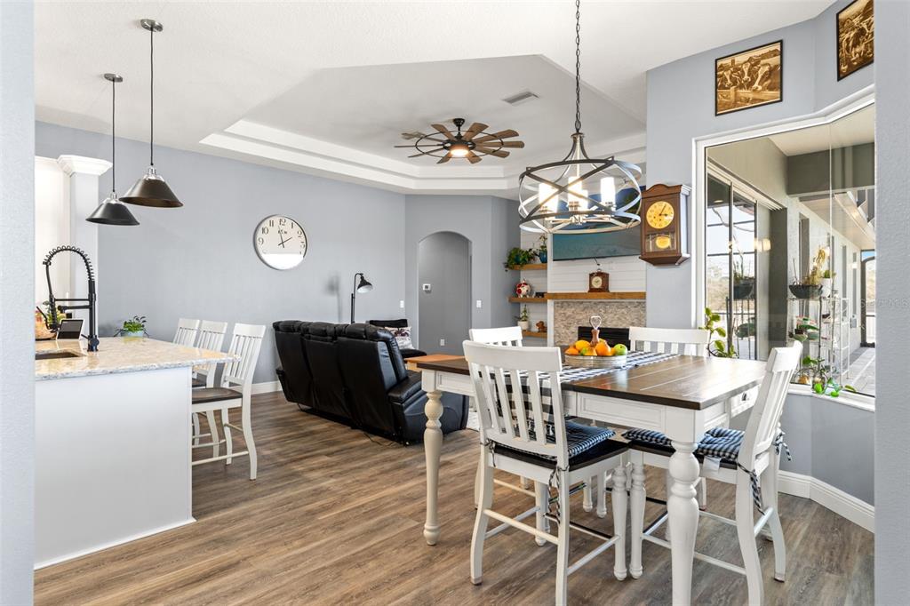 12277 Eskimo Curlew Road Weeki Wachee, FL 34614 - Photo 17 of 84 a view of a dining room with furniture and wooden floor