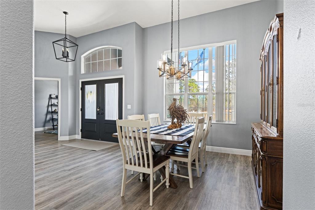 12277 Eskimo Curlew Road Weeki Wachee, FL 34614 - Photo 23 of 84 a view of a dining room with furniture window and wooden floor