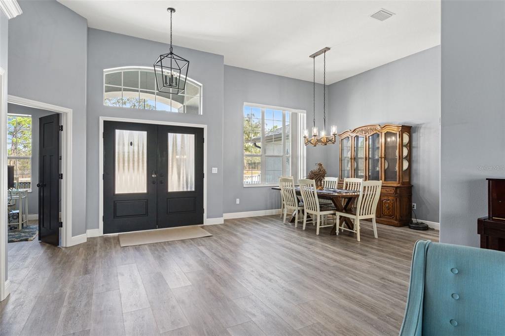 12277 Eskimo Curlew Road Weeki Wachee, FL 34614 - Photo 24 of 84 a view of a dining room with furniture window and wooden floor