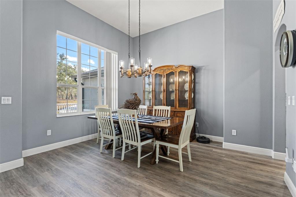 12277 Eskimo Curlew Road Weeki Wachee, FL 34614 - Photo 25 of 84 a view of a dining room with furniture window and wooden floor