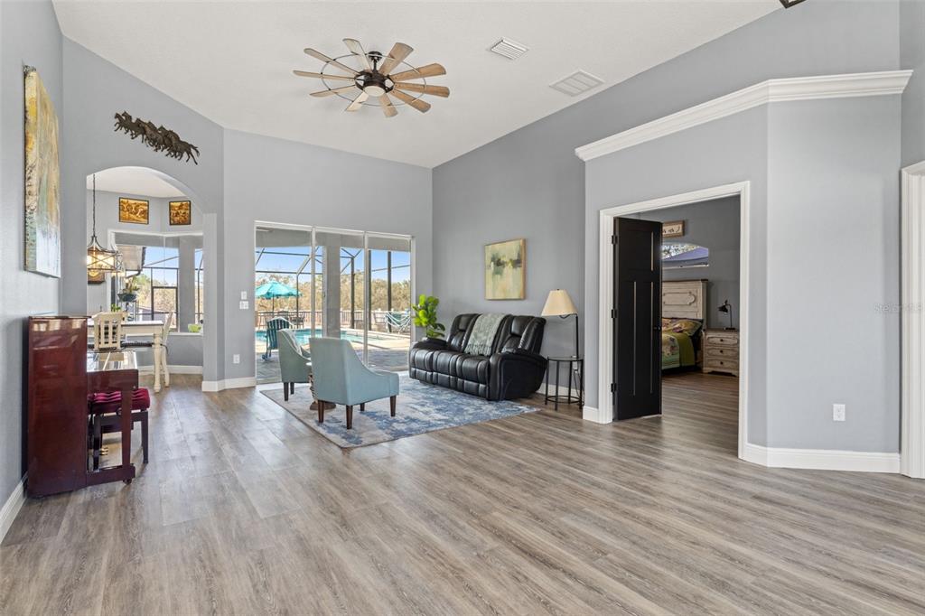 12277 Eskimo Curlew Road Weeki Wachee, FL 34614 - Photo 26 of 84 a living room with furniture and wooden floor