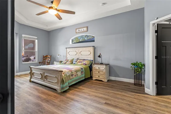 a view of a livingroom with wooden floor and a flat screen tv
