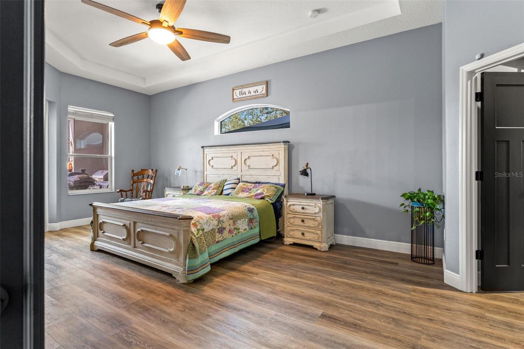 12277 Eskimo Curlew Road Weeki Wachee, FL 34614 - Photo 27 of 84 a bedroom with a bed and a potted plant