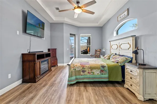 a bedroom with a bed and a chandelier