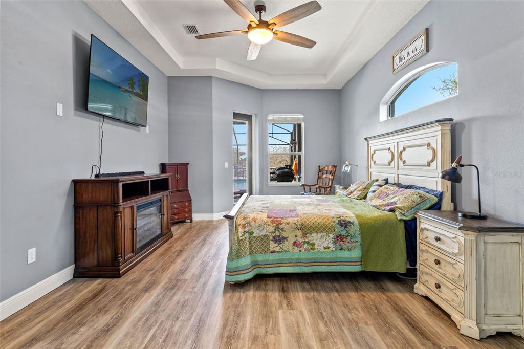 12277 Eskimo Curlew Road Weeki Wachee, FL 34614 - Photo 28 of 84 a bedroom with a bed and a flat tv screen on dresser