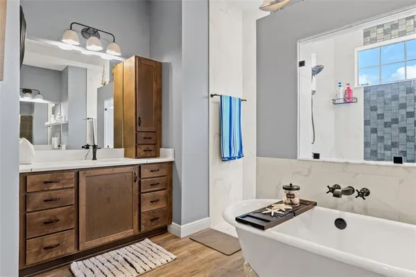 a bathroom with a granite countertop sink toilet and mirror