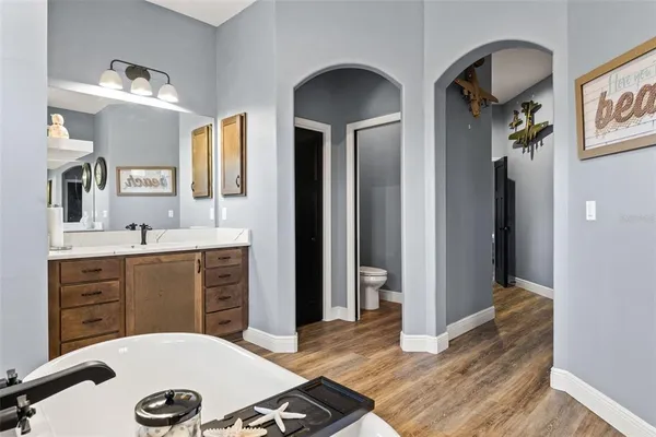 a bathroom with a granite countertop sink a mirror and shower