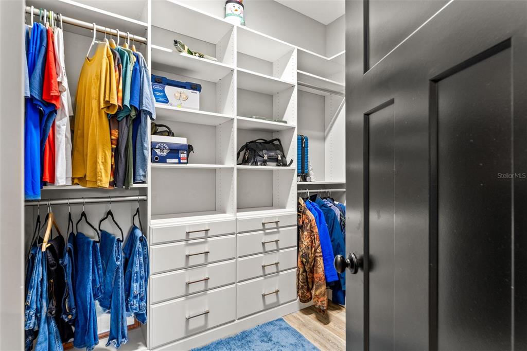 12277 Eskimo Curlew Road Weeki Wachee, FL 34614 - Photo 36 of 84 a view of walk in closet with clothes and shoes