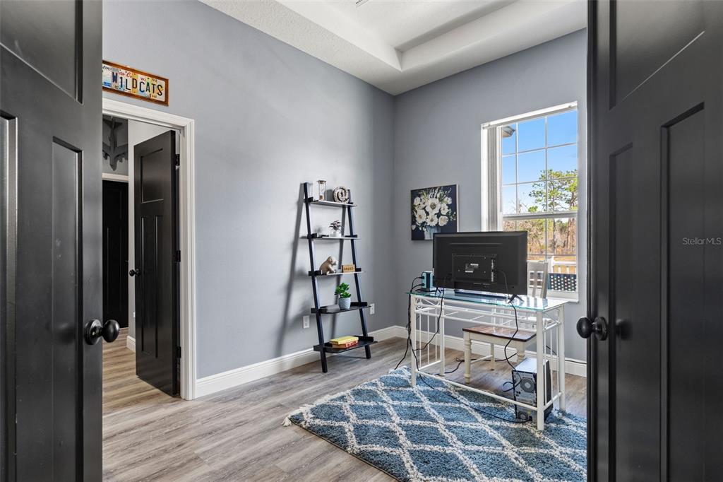 12277 Eskimo Curlew Road Weeki Wachee, FL 34614 - Photo 38 of 84 a view of a livingroom with wooden floor and a flat screen tv