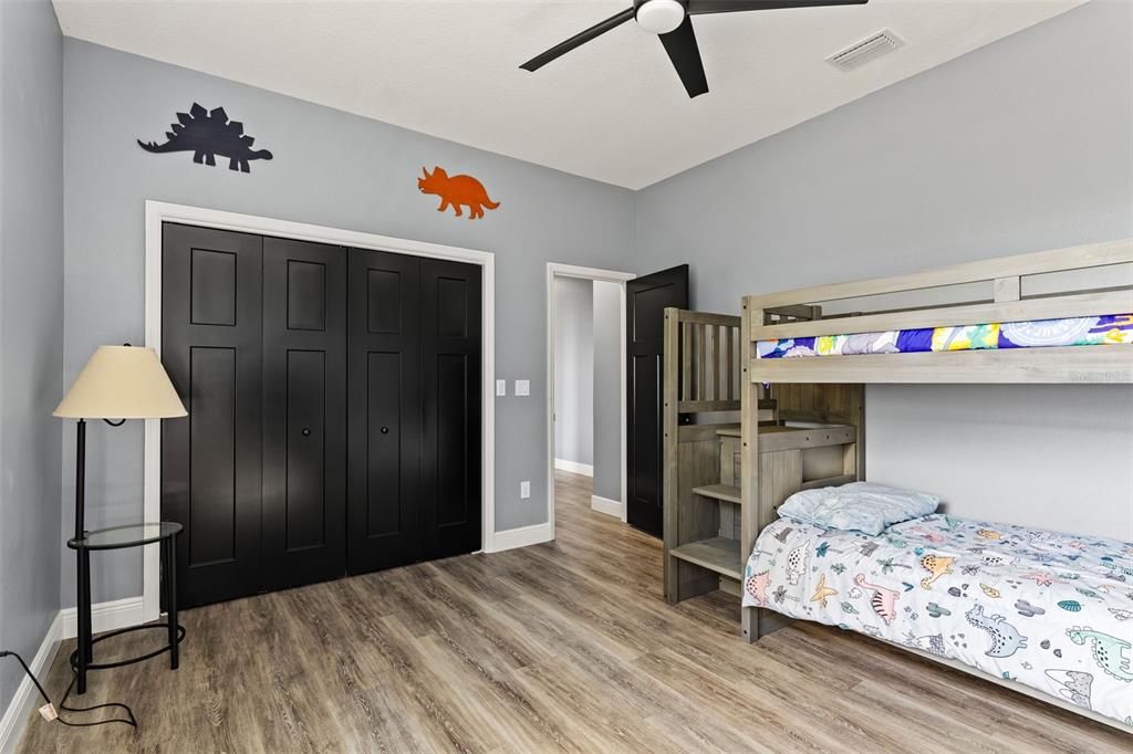 12277 Eskimo Curlew Road Weeki Wachee, FL 34614 - Photo 39 of 84 a bedroom with a bed and a chandelier