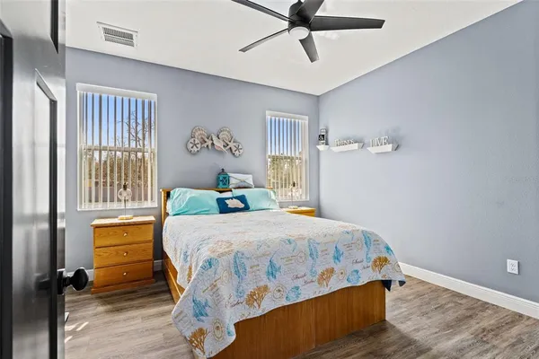 a view of a balcony with wooden floor and outdoor seating