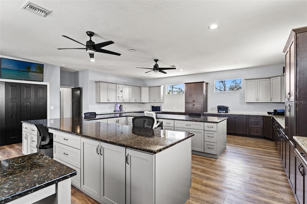 12277 Eskimo Curlew Road Weeki Wachee, FL 34614 - Photo 50 of 84 a kitchen with stainless steel appliances granite countertop a sink stove and refrigerator