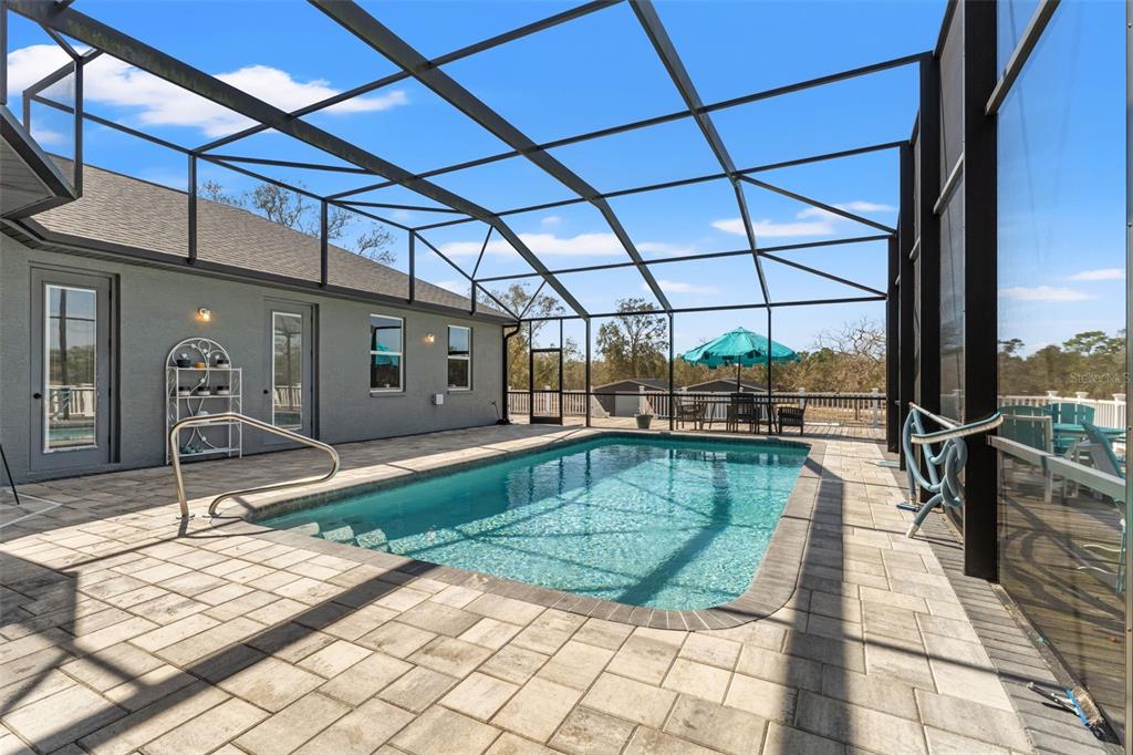 12277 Eskimo Curlew Road Weeki Wachee, FL 34614 - Photo 58 of 84 a view of a swimming pool with a patio