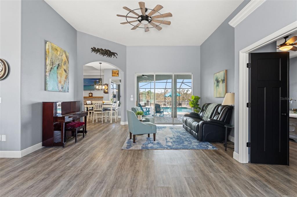 12277 Eskimo Curlew Road Weeki Wachee, FL 34614 - Photo 7 of 84 a living room with fireplace furniture and a wooden floor