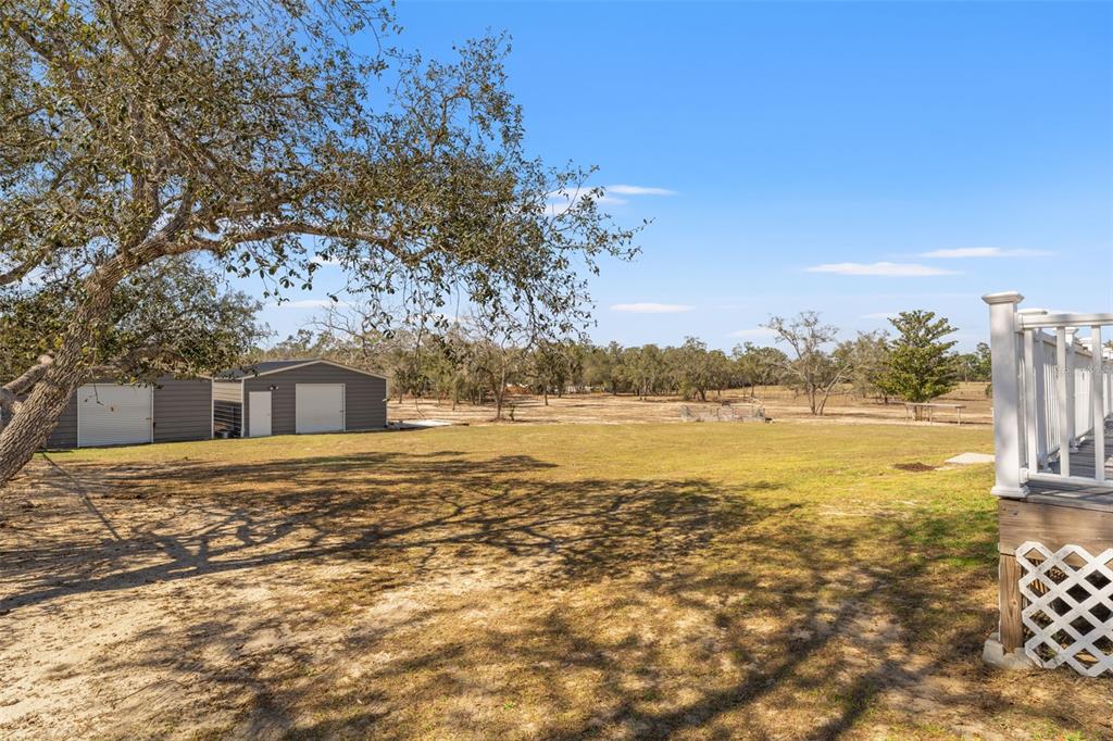 12277 Eskimo Curlew Road Weeki Wachee, FL 34614 - Photo 72 of 84 a view of a lake with a house in the background