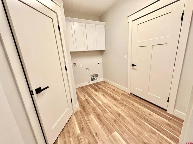 a view of a closet with wooden floor