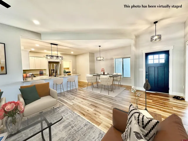 a living room with furniture kitchen view and a table