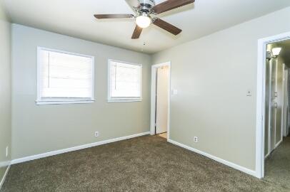 5408 31st Street Lubbock, TX 79407 - Photo 18 of 33 an empty room with windows and fan