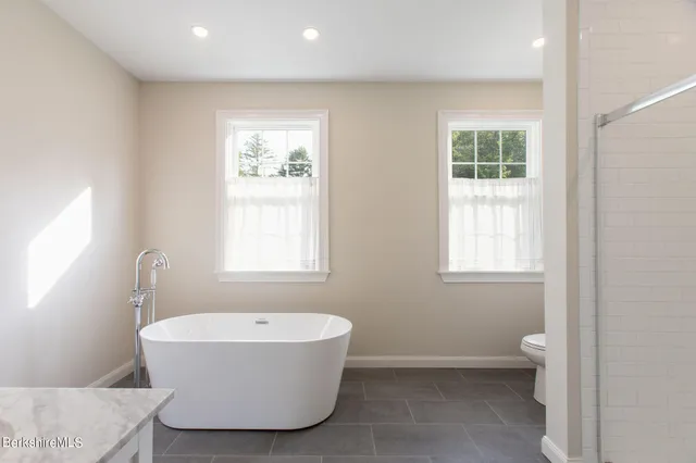 a bathroom with a bathtub and a window