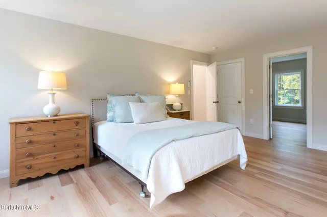 a bedroom with a bed and a lamp