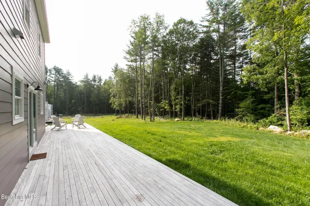 a view of a backyard with large trees