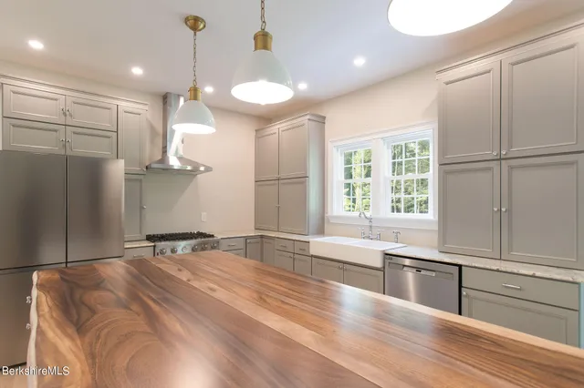 a view of a kitchen with a sink and wooden floor
