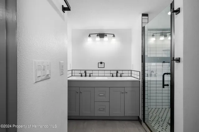 a bathroom with a shower and a sink