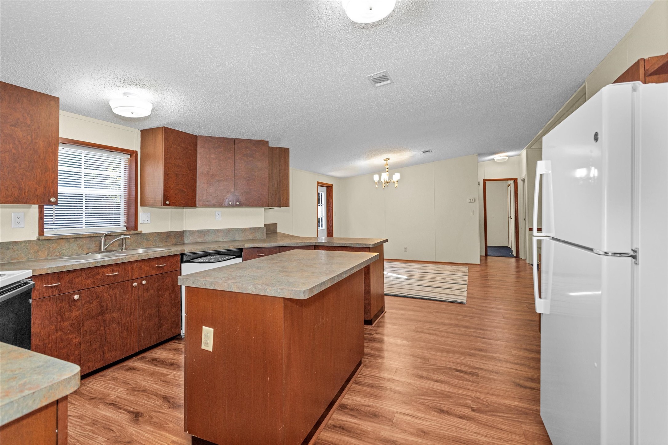11261 Rose Road Conroe, TX 77303 - Photo 11 of 30 a kitchen with stainless steel appliances granite countertop a table chairs sink and cabinets