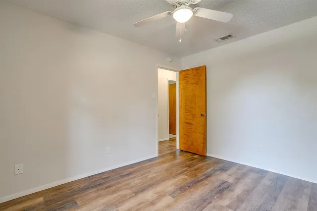 an empty room with a empty space and a ceiling fan