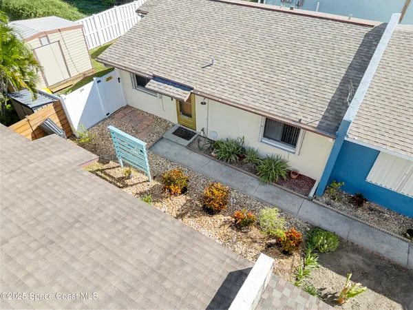 an aerial view of a house with a yard and garden