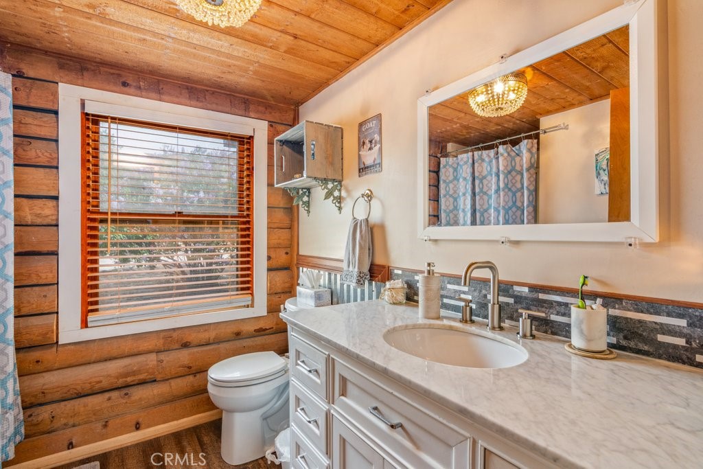 37325 Bohlen Road Anza, CA 92539 - Photo 18 of 43 a bathroom with a granite countertop sink toilet and a large mirror