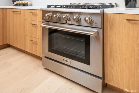 a stove top oven sitting inside of a kitchen