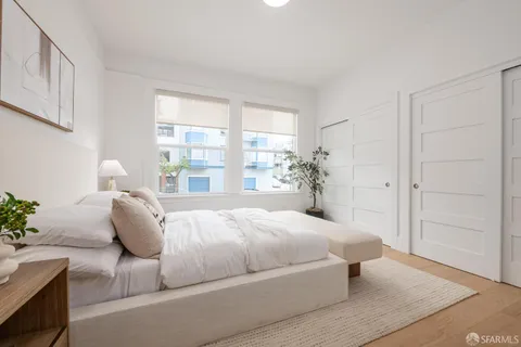 a bedroom with a bed and a couch