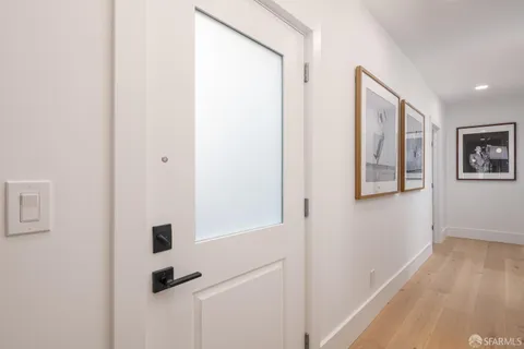 a view of front door with wooden floor