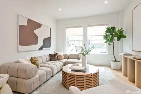 a living room with furniture flowerpot and a window
