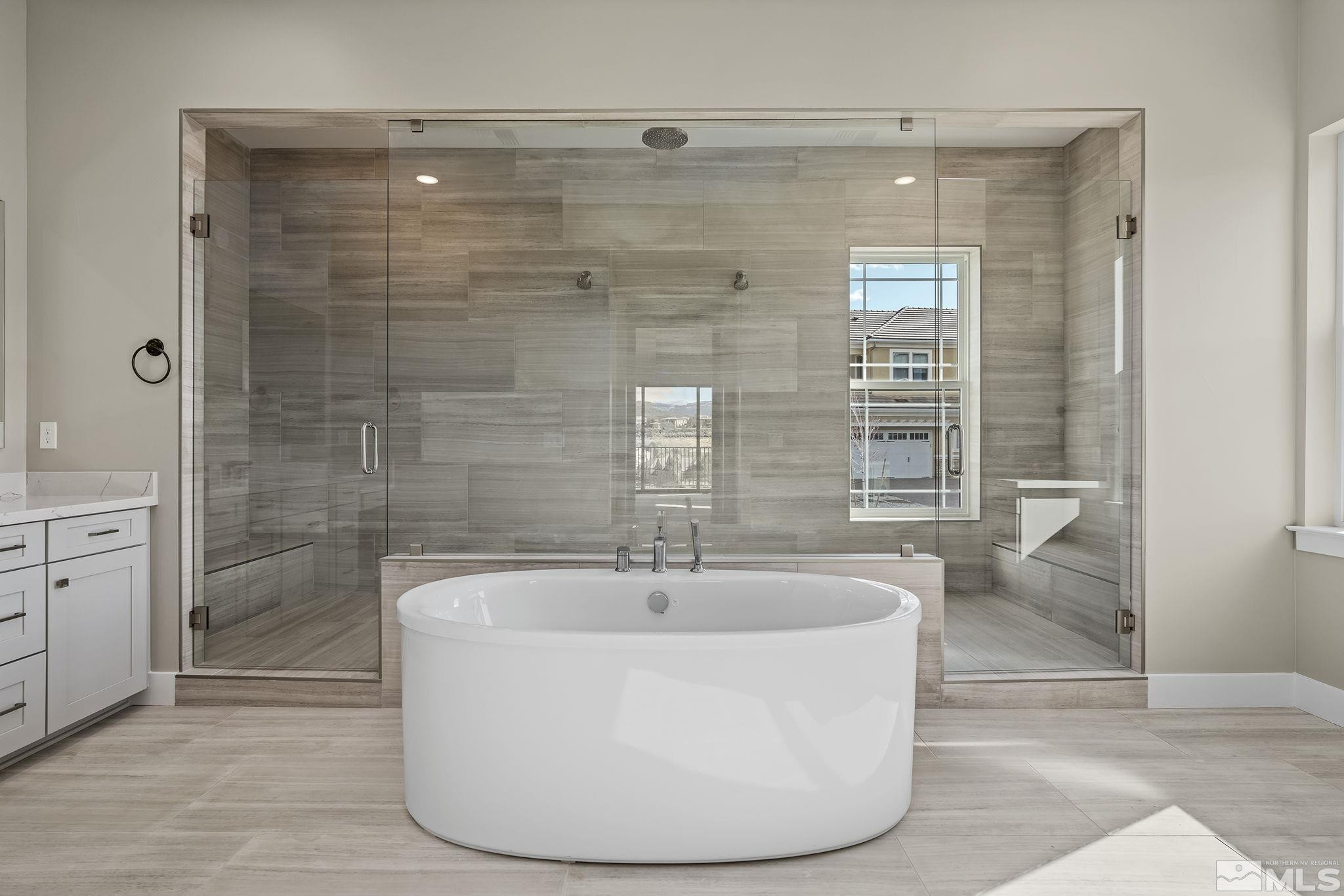 1765 Boulder Ridge Court Reno, NV 89523 - Photo 16 of 36 a white bath tub sitting in a bathroom and shower
