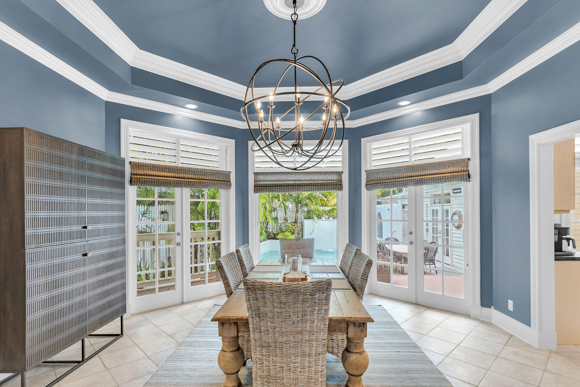 64 Front Street Key West, FL 33040 - Photo 14 of 57 a dining room with furniture a chandelier and wooden floor