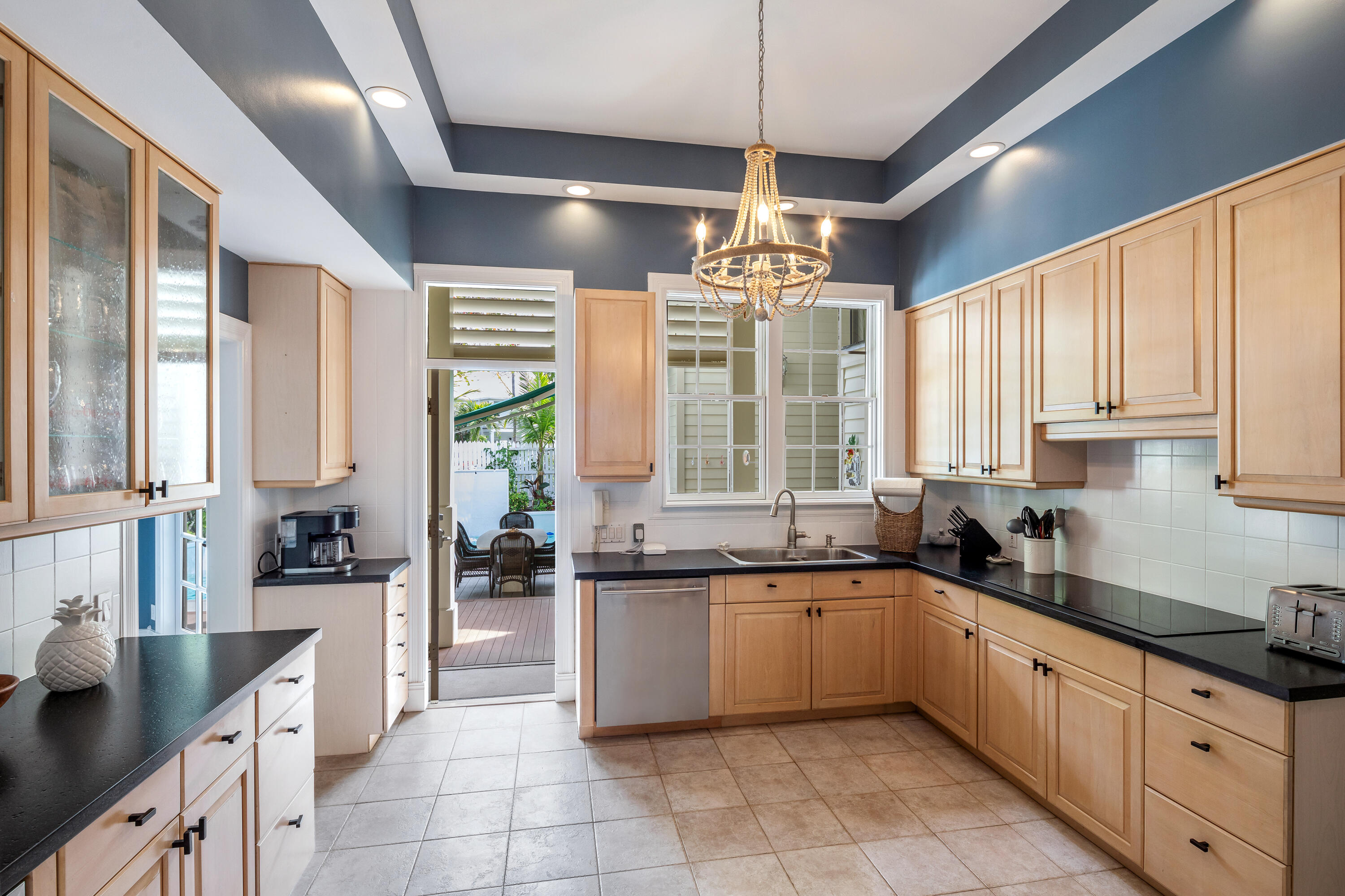 64 Front Street Key West, FL 33040 - Photo 17 of 57 a large kitchen with a large window and cabinets