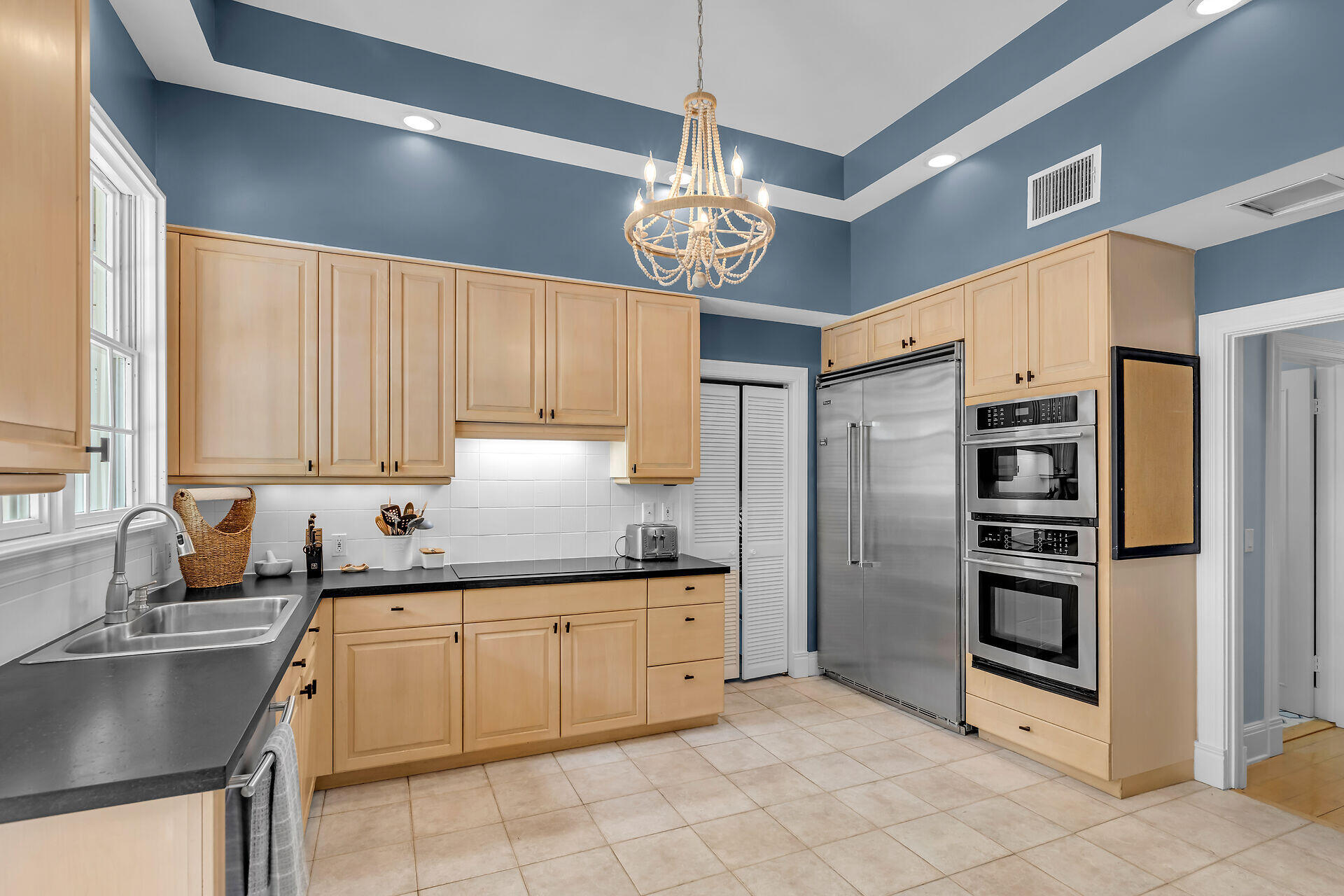 64 Front Street Key West, FL 33040 - Photo 19 of 57 a kitchen that has a lot of cabinets in it and appliances