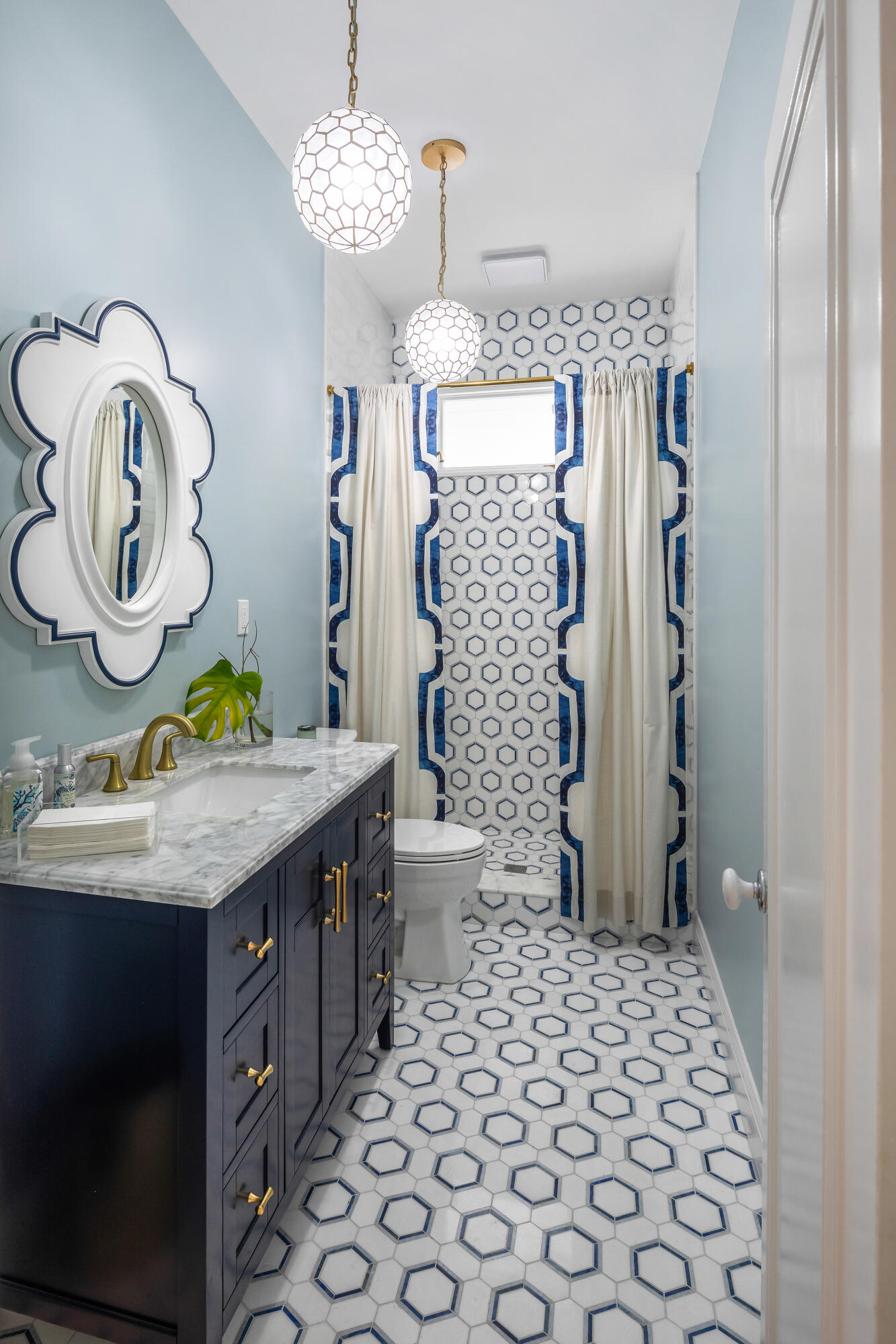 64 Front Street Key West, FL 33040 - Photo 22 of 57 a bathroom with a sink a toilet and shower curtain