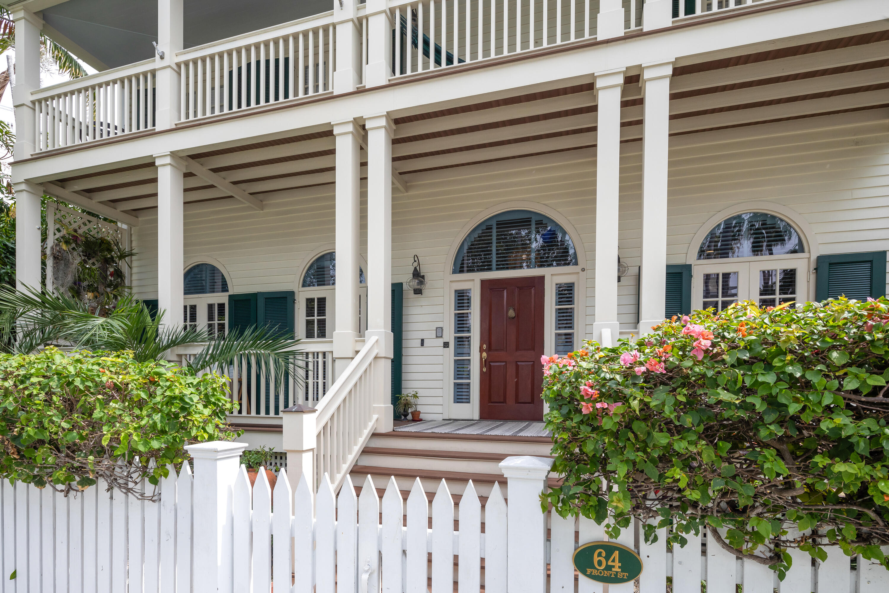 64 Front Street Key West, FL 33040 - Photo 3 of 57 a front view of a house with a garden