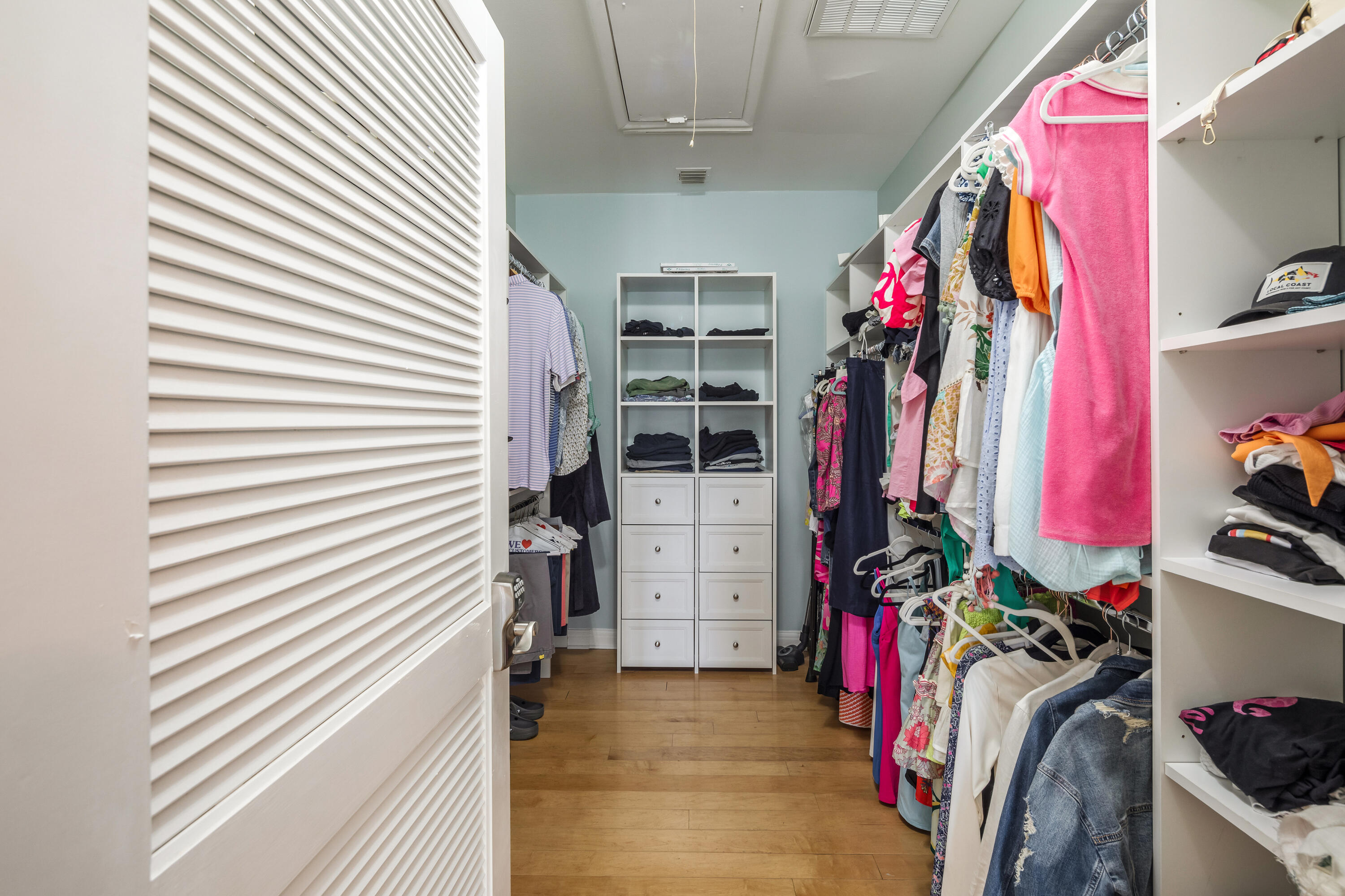 64 Front Street Key West, FL 33040 - Photo 32 of 57 a view of walk in closet with clothes and shoes