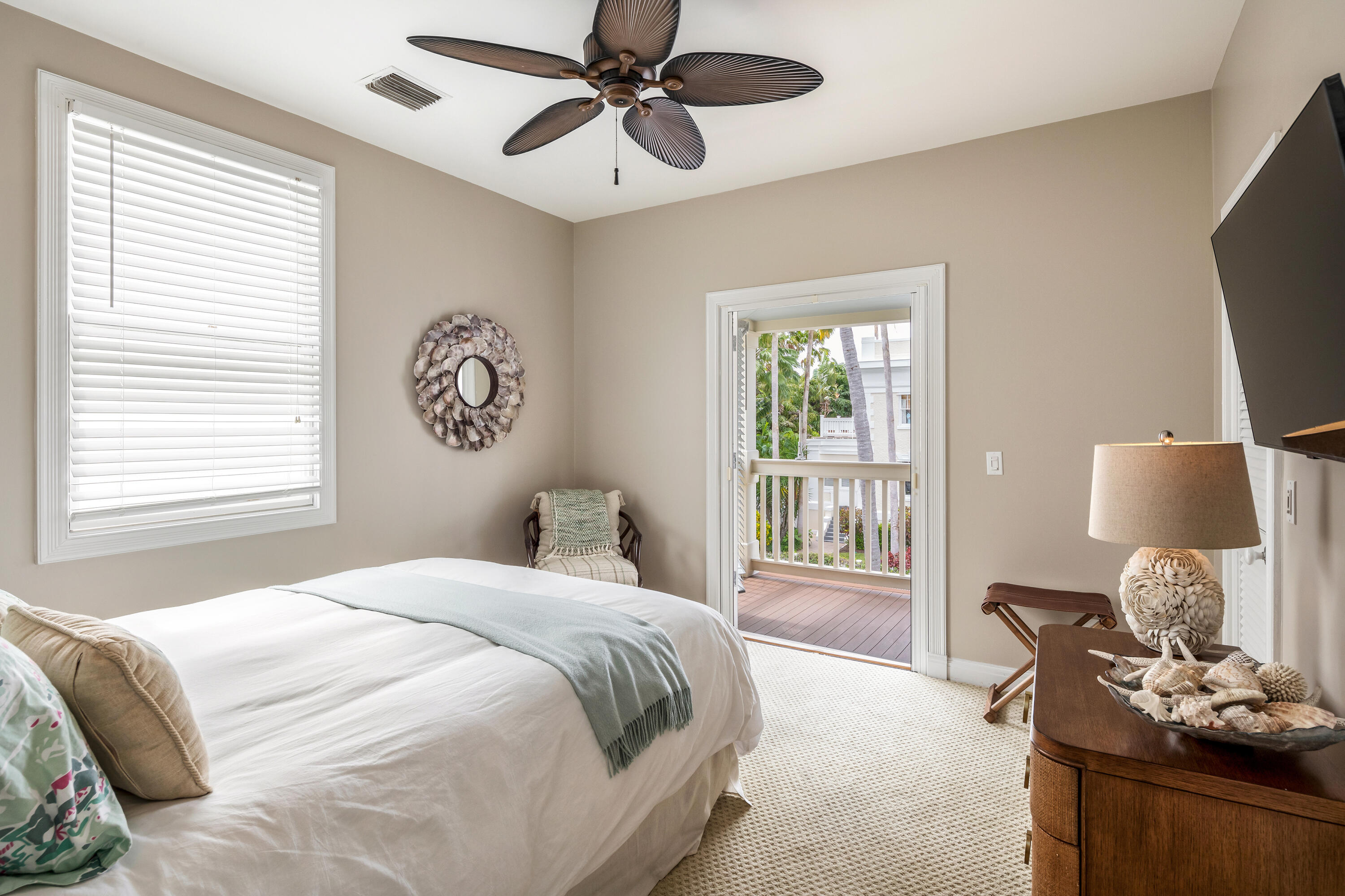 64 Front Street Key West, FL 33040 - Photo 39 of 57 a bedroom with a bed and glass window