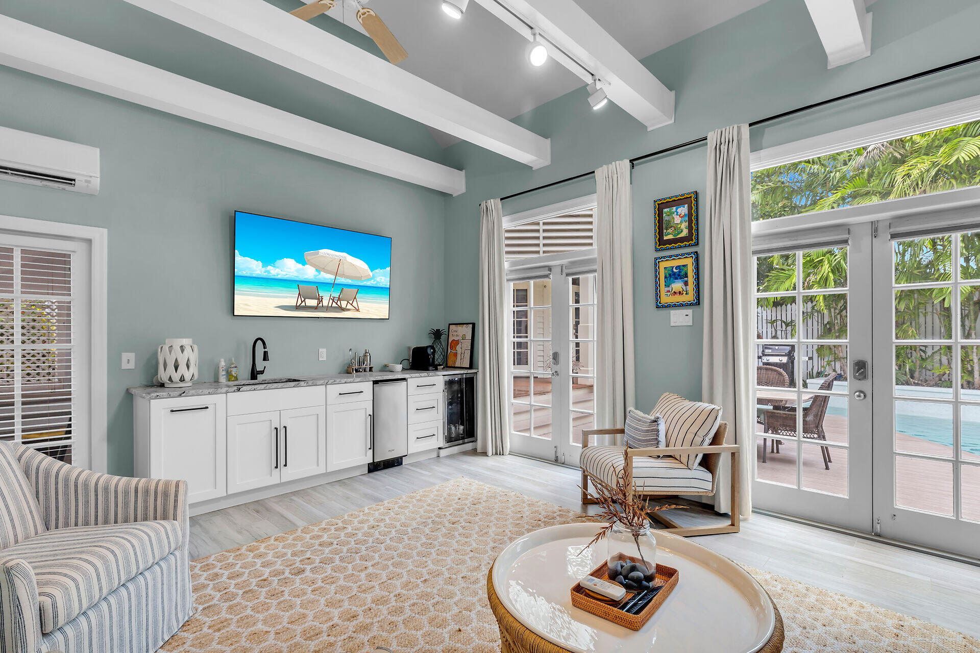 64 Front Street Key West, FL 33040 - Photo 48 of 57 a living room with furniture and a flat screen tv