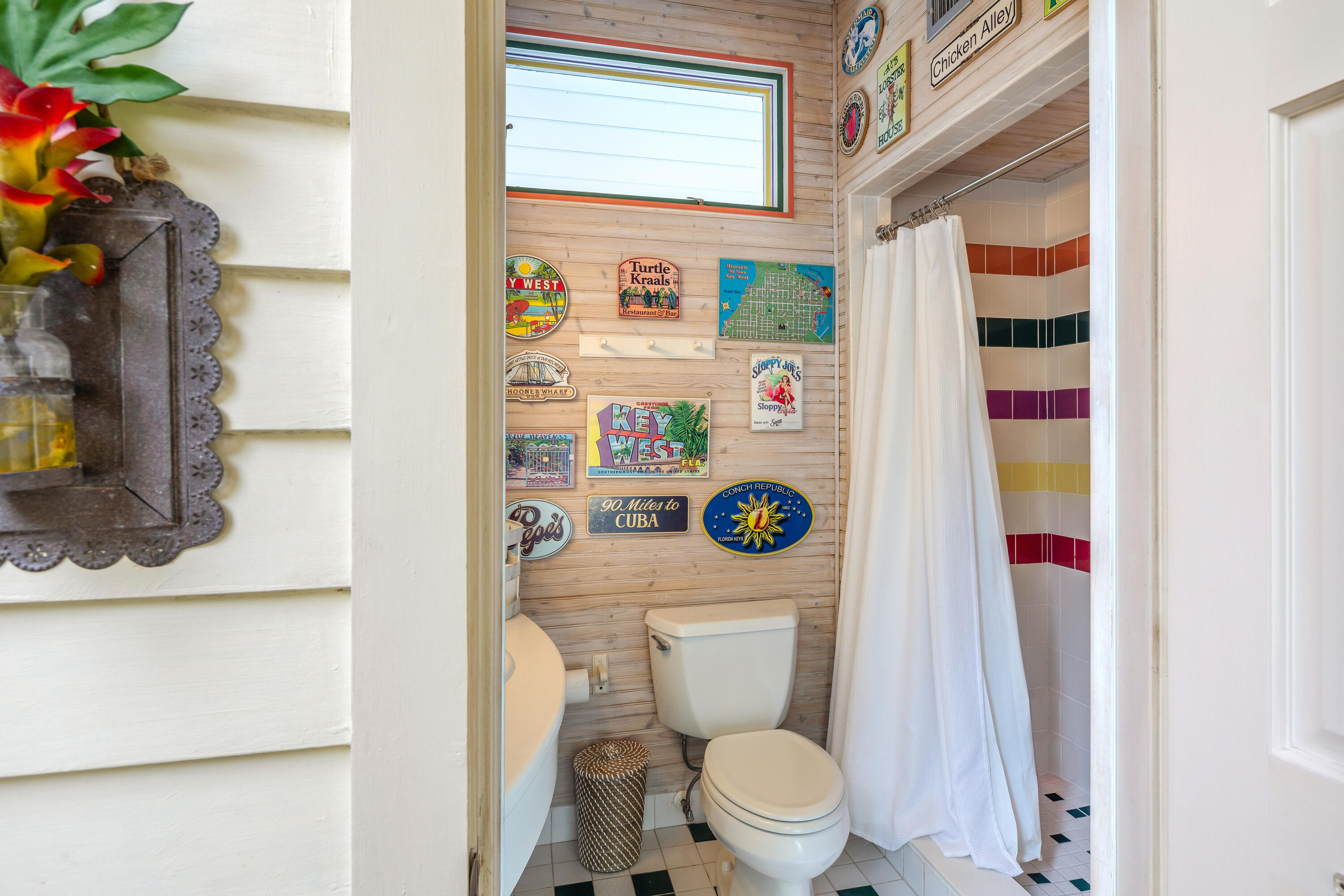 64 Front Street Key West, FL 33040 - Photo 49 of 57 a white toilet sitting next to a bathroom sink