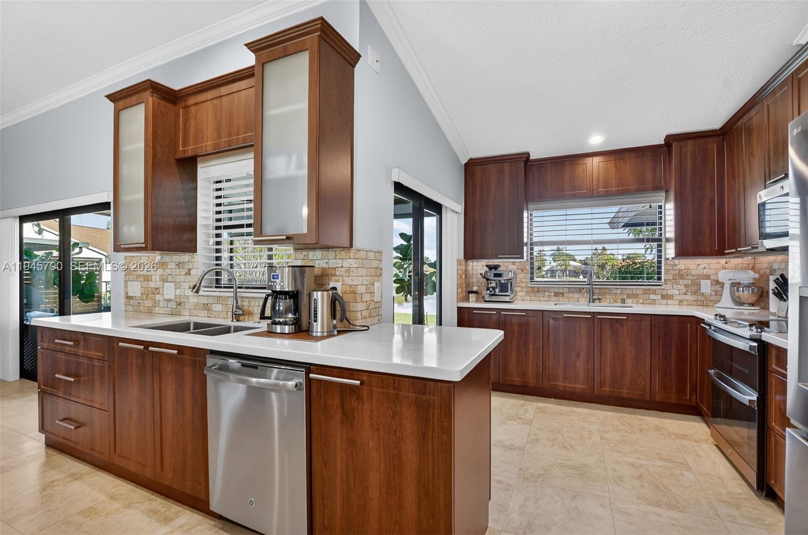 9943 Majorca Place Boca Raton, FL 33434 - Photo 15 of 48 a kitchen with stainless steel appliances granite countertop a sink stove and cabinets
