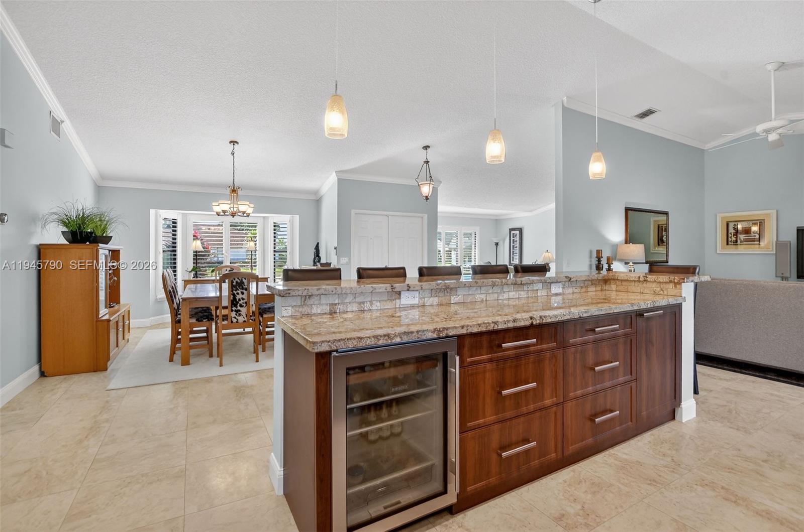9943 Majorca Place Boca Raton, FL 33434 - Photo 16 of 48 a large kitchen with a table and chairs