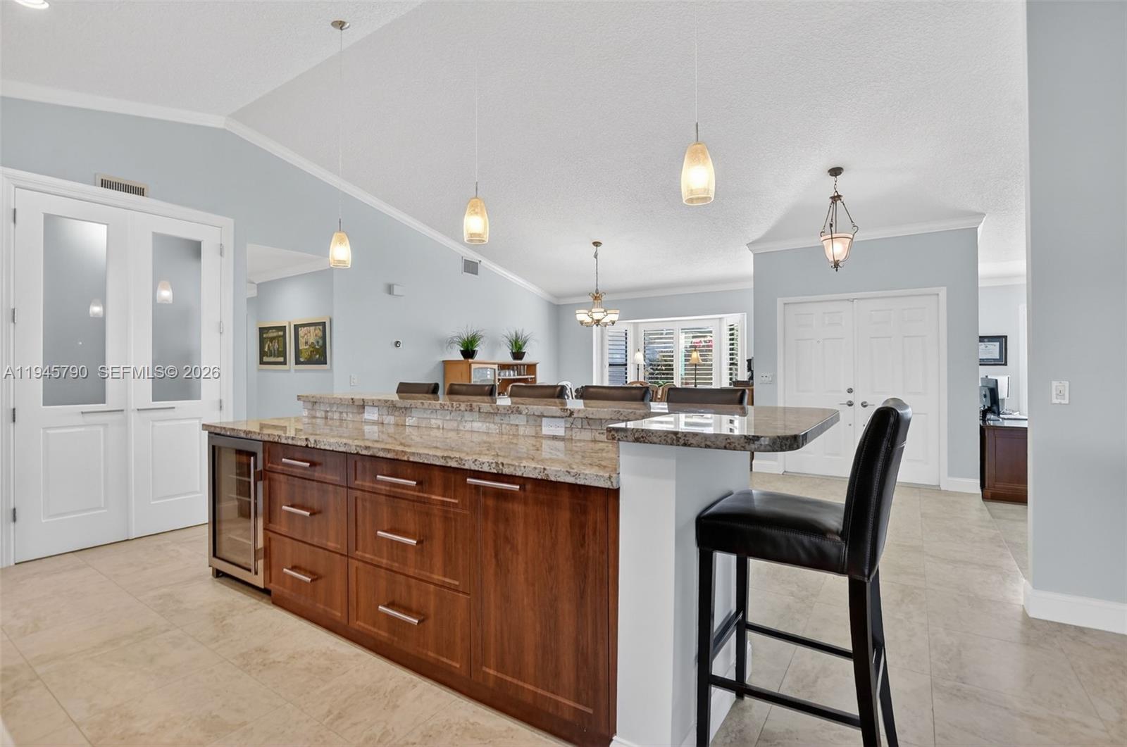 9943 Majorca Place Boca Raton, FL 33434 - Photo 17 of 48 a kitchen with granite countertop wooden cabinets and dining table
